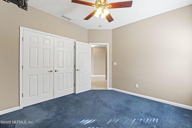 unfurnished bedroom with ceiling fan, a closet, and carpet floors