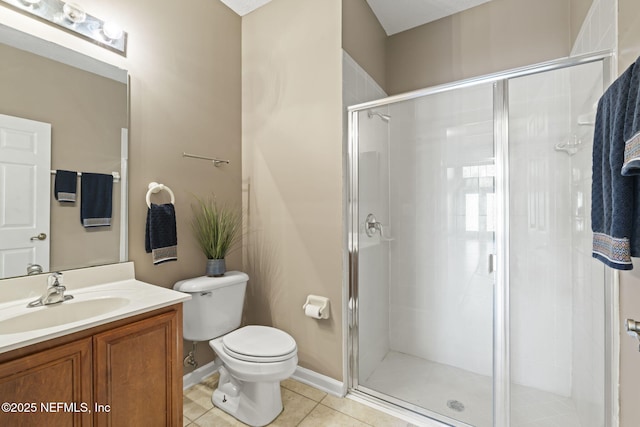 bathroom featuring toilet, tile patterned floors, a shower with door, and vanity