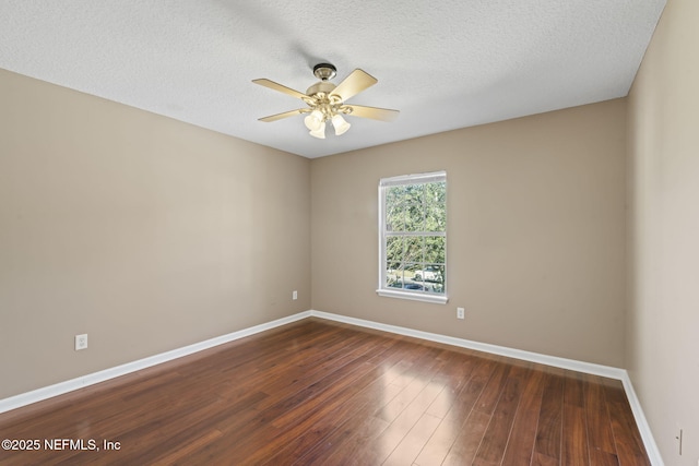 empty room featuring a textured ceiling, ceiling fan, and dark hardwood / wood-style flooring