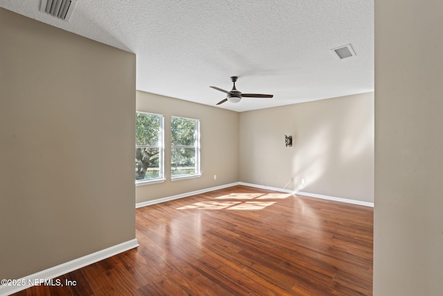 empty room featuring ceiling fan, hardwood / wood-style floors, and a textured ceiling