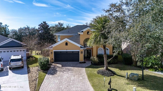 view of front of home with a front yard and a garage