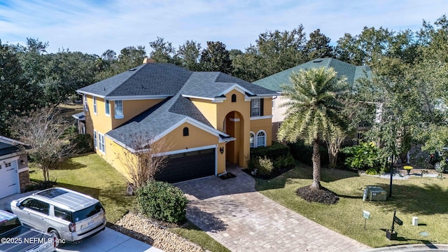 view of front of property featuring a front lawn and a garage