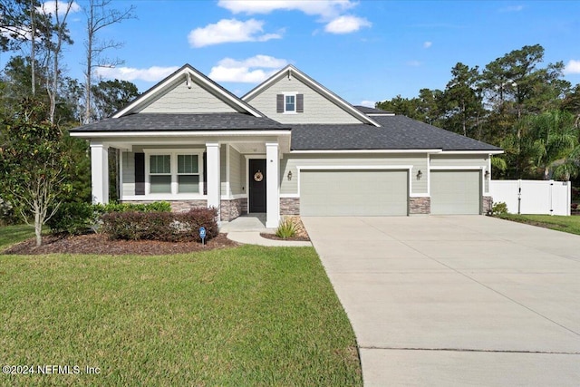 view of front of home with a front yard and a garage