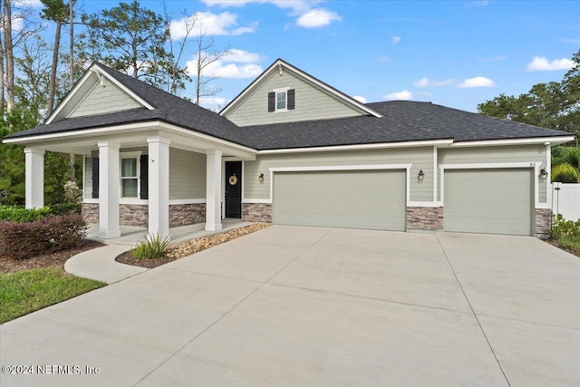 view of front of house with a porch and a garage