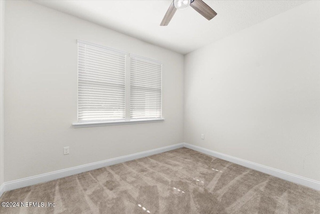 carpeted empty room featuring ceiling fan