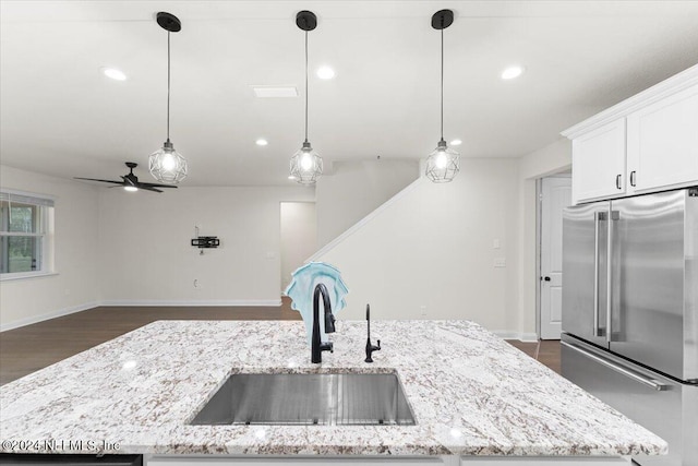 kitchen featuring hanging light fixtures, ceiling fan, high quality fridge, and sink