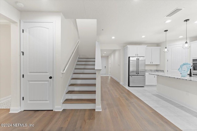 stairs featuring wood-type flooring