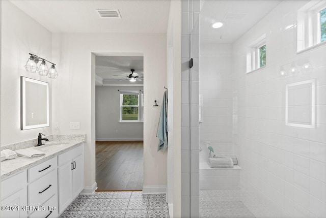 bathroom featuring hardwood / wood-style floors, ceiling fan, a healthy amount of sunlight, and a shower with door