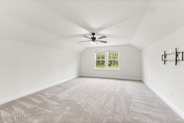 bonus room with ceiling fan, light carpet, and vaulted ceiling