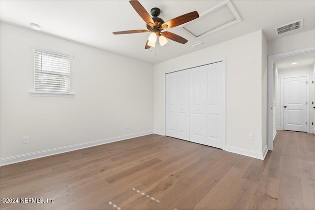 unfurnished bedroom with a closet, ceiling fan, and hardwood / wood-style floors