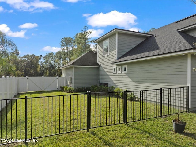 view of side of home with a yard