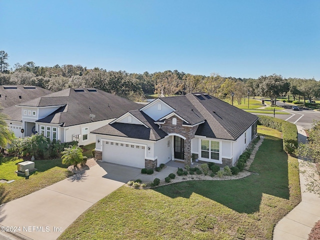 view of front of property with a front yard and a garage