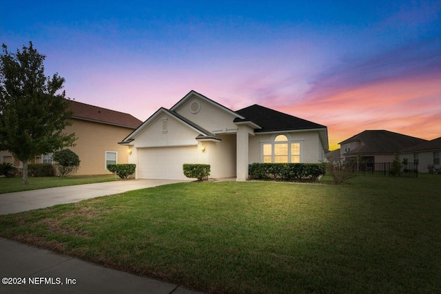 ranch-style home with a lawn and a garage