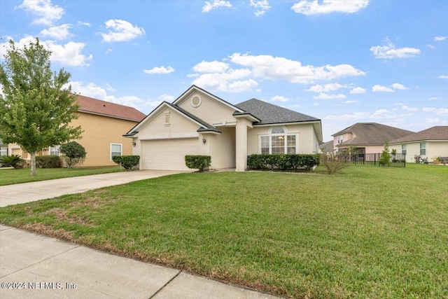 view of front of home with a front yard and a garage