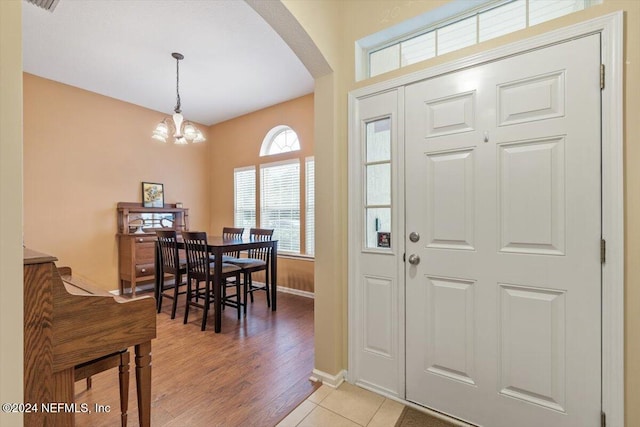 foyer featuring a chandelier and light wood-type flooring