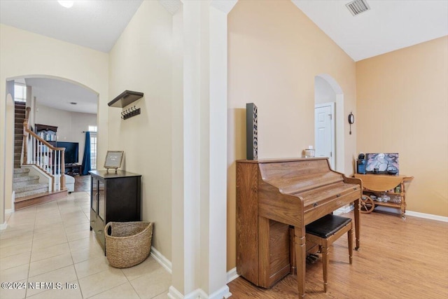 interior space featuring light hardwood / wood-style floors and vaulted ceiling