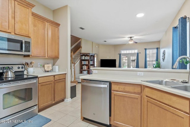 kitchen with sink, ceiling fan, light brown cabinetry, light tile patterned flooring, and stainless steel appliances