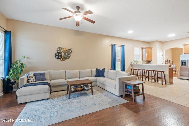 living room with hardwood / wood-style flooring and ceiling fan