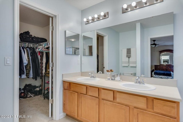 bathroom with ceiling fan and vanity