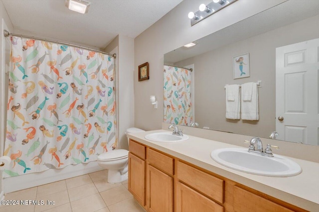 full bathroom with shower / bath combo, vanity, a textured ceiling, tile patterned flooring, and toilet