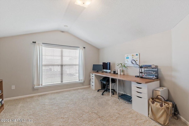 home office featuring light colored carpet, a textured ceiling, and vaulted ceiling