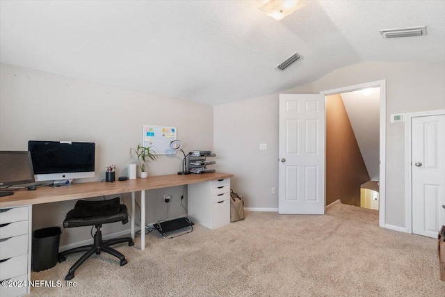 carpeted office featuring vaulted ceiling