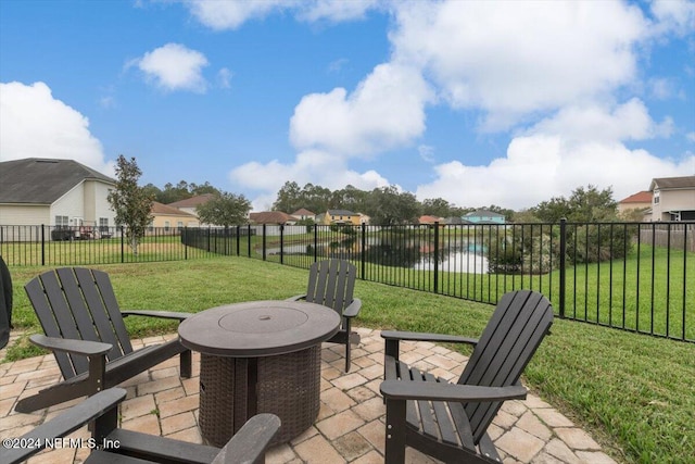 view of patio with a water view and an outdoor fire pit