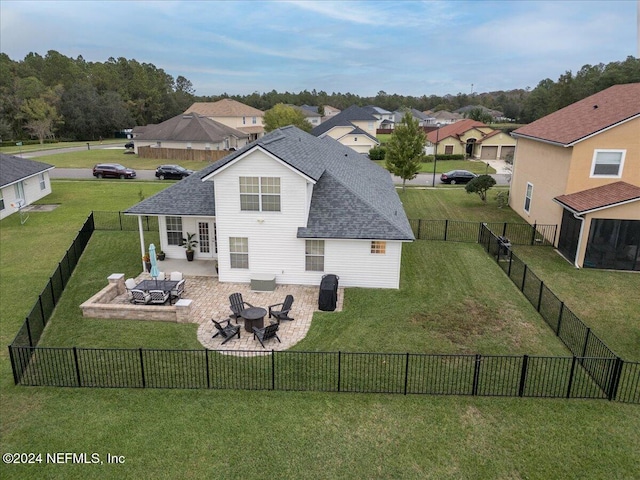 back of property with outdoor lounge area, a yard, and a patio area