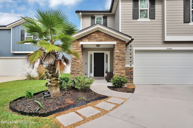 view of exterior entry featuring a garage