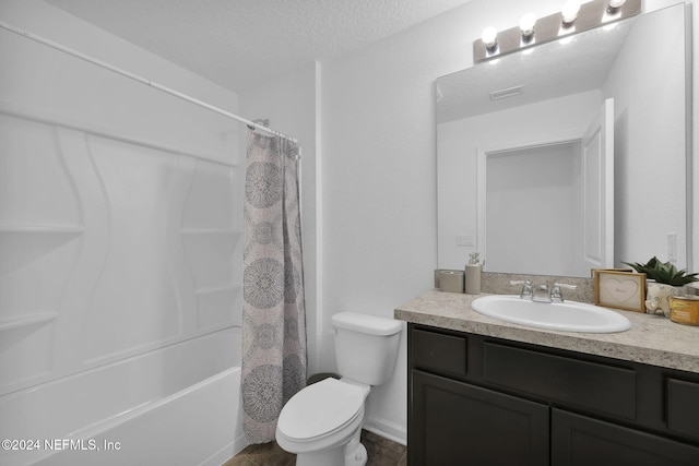 full bathroom featuring a textured ceiling, vanity, shower / tub combo, and toilet