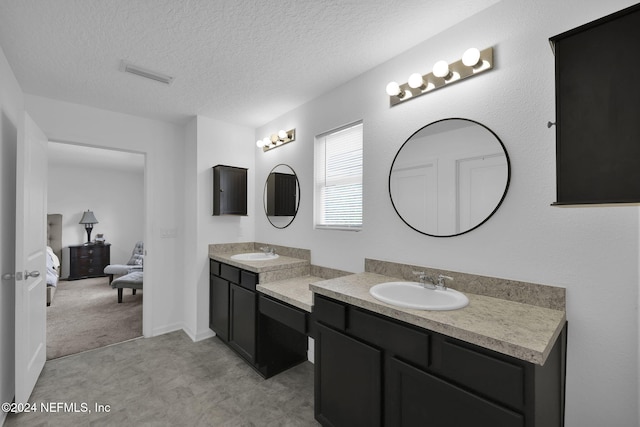 bathroom with vanity and a textured ceiling