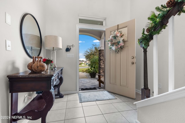 foyer entrance with light tile patterned flooring