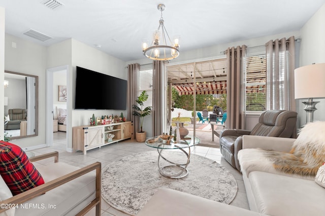 living room with light tile patterned floors and a chandelier