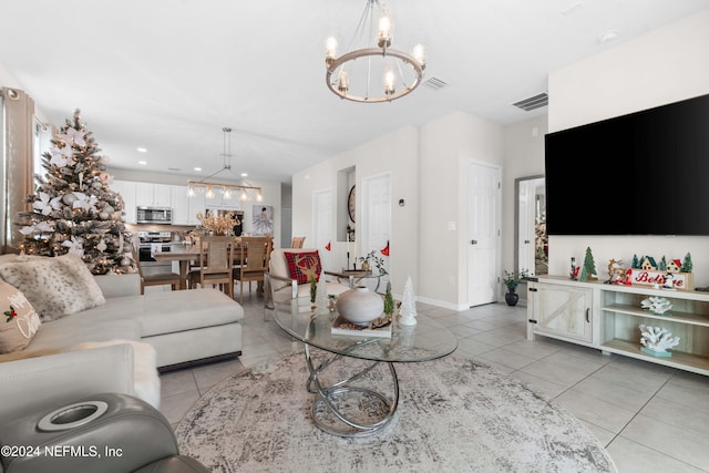 living room with a notable chandelier and light tile patterned floors