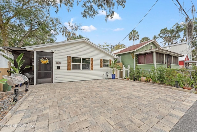 view of front of home with a patio and a sunroom