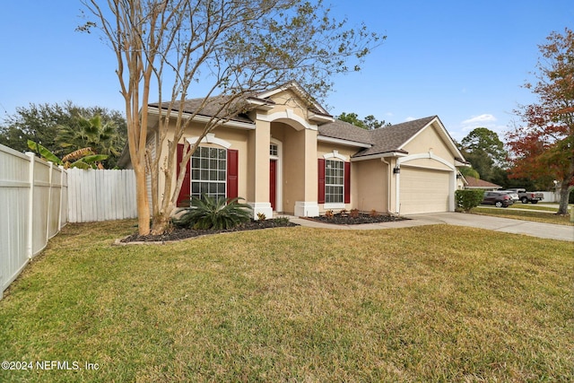 view of front of house featuring a garage and a front lawn