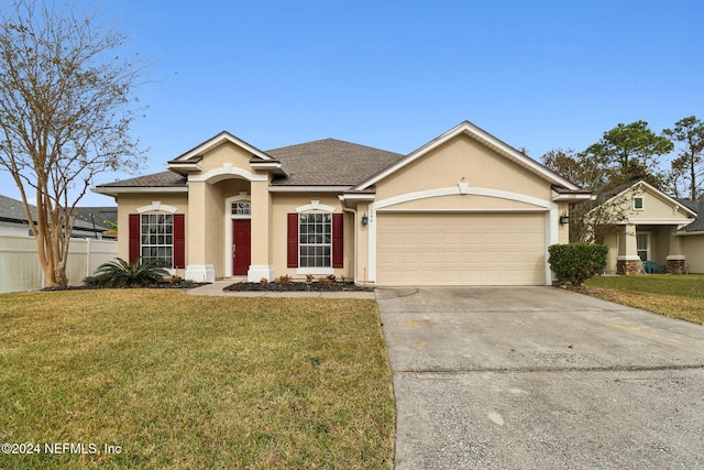 ranch-style house featuring a garage and a front lawn