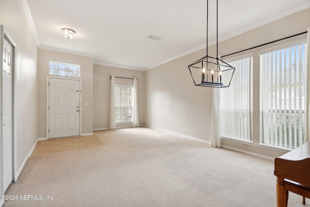 entryway featuring light colored carpet, an inviting chandelier, and crown molding