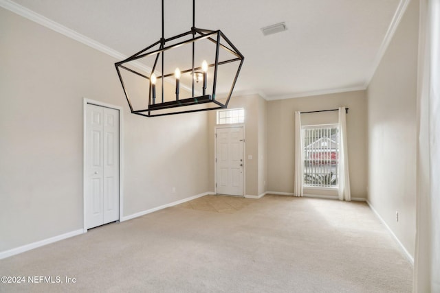 carpeted spare room with a notable chandelier and ornamental molding