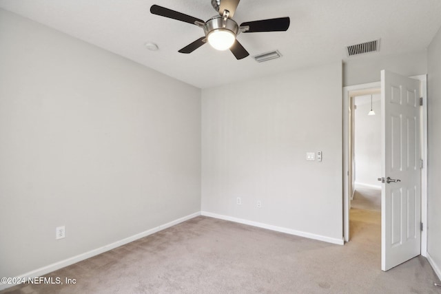 unfurnished room featuring light colored carpet and ceiling fan