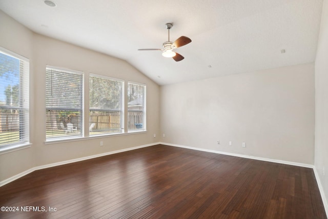 empty room with ceiling fan, dark wood-type flooring, and lofted ceiling