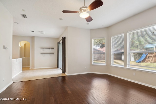 empty room featuring ceiling fan and light hardwood / wood-style flooring