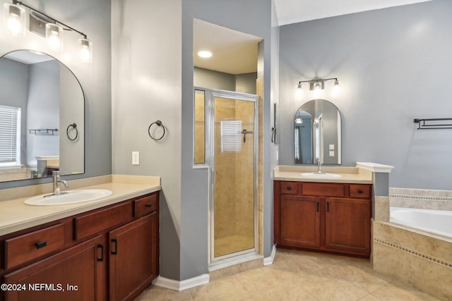 bathroom featuring tile patterned flooring, vanity, and shower with separate bathtub