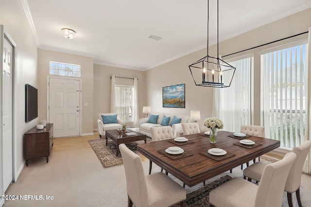 dining room with a chandelier, a wealth of natural light, and ornamental molding