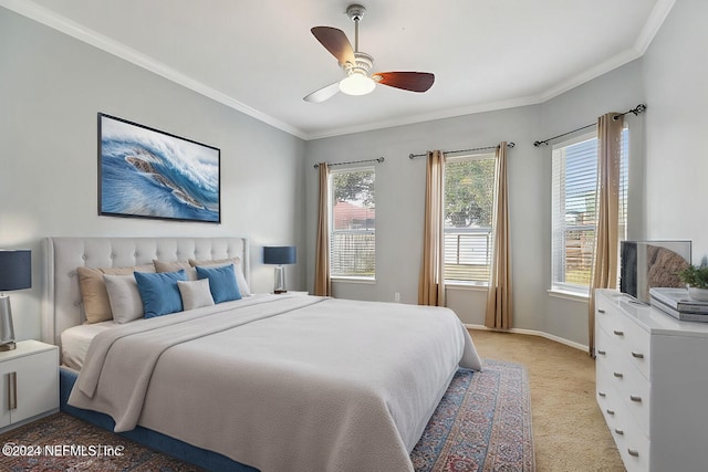 carpeted bedroom with ceiling fan and crown molding