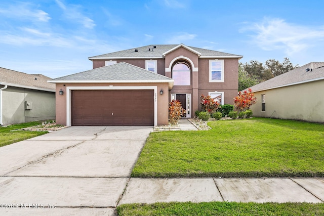 front facade with a front yard and a garage