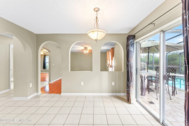 spare room with ceiling fan and a textured ceiling