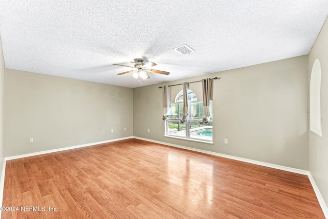 unfurnished room featuring a textured ceiling, light wood-type flooring, and ceiling fan