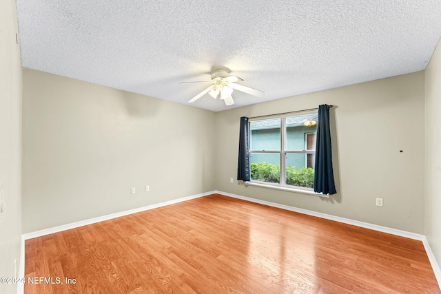 spare room featuring ceiling fan, a textured ceiling, and hardwood / wood-style flooring