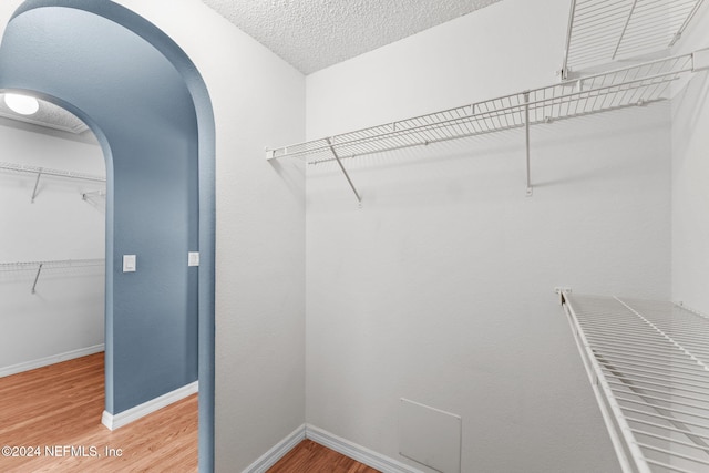 walk in closet featuring hardwood / wood-style floors